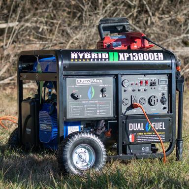 the DuroMax 13000 Watt Dual Fuel Portable Generator hooked up outside with a chainsaw