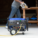 the DuroMax 5500 Watt Dual Fuel Portable Generator powering a saw